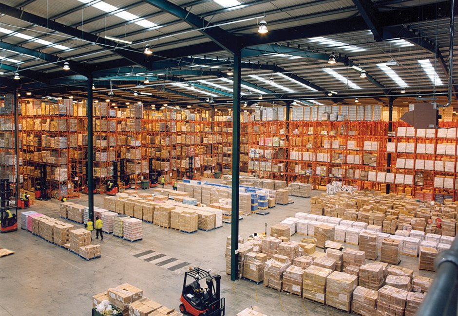 Palletized freight stored safely inside Courex modern warehouse racks