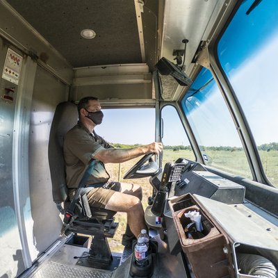 Courex uniformed courier driver with delivery vehicle